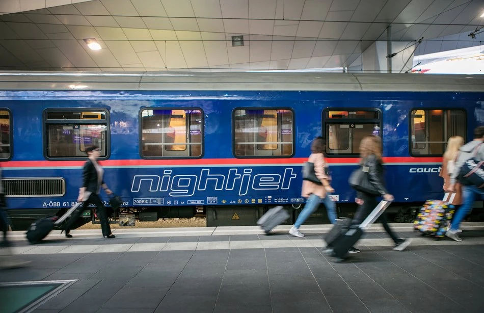 A European night train departing at dusk