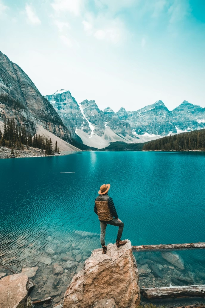 Solo traveler overlooking a mountain lake